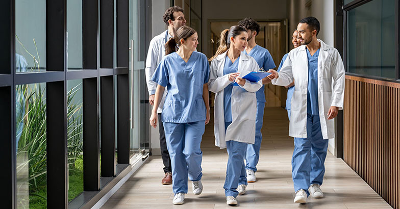 Medical team collaborating in hospital corridor on dispute resolution